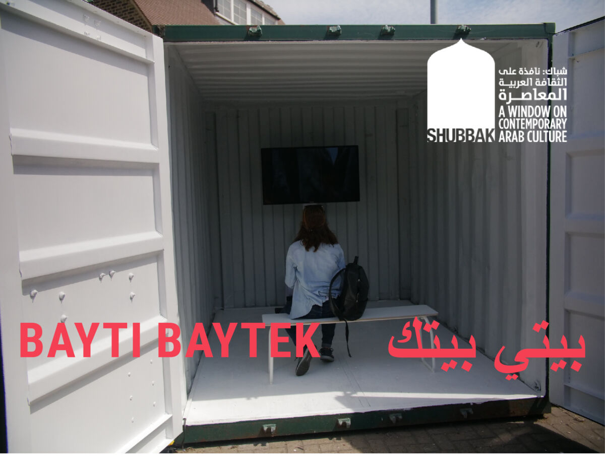 A woman sitting in a shipping container