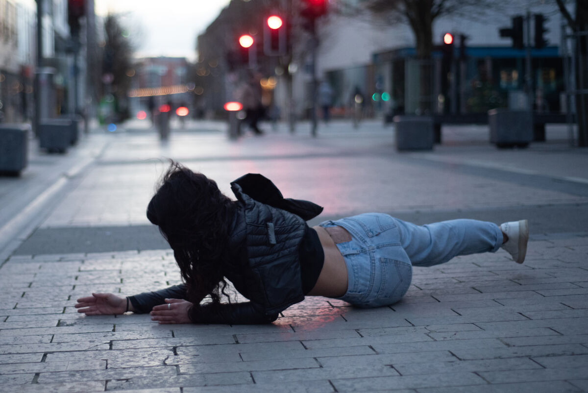 dancer performing on a street pavement