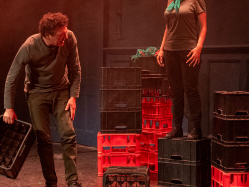 crates on stage, a man and woman standing